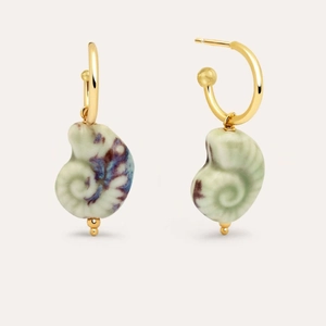 Detail of gold hoop earrings with turquoise shell pendants and purple marble texture