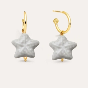 Detail of 18K gold hoop earrings with grey ceramic starfish pendants in minimalist style