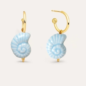Detail view of 18K gold hoop earrings with light blue conch pendants and glossy finish
