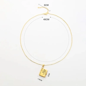 Detail of book-shaped gold pendant necklace with My Little Star engraving and heart