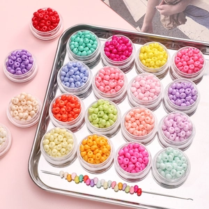 Detailed macro view of 5mm colorful glass beads in clear storage containers for DIY crafts