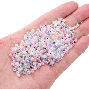Perles de rocaille 4mm couleurs macaron pour bijoux DIY présentées dans la main