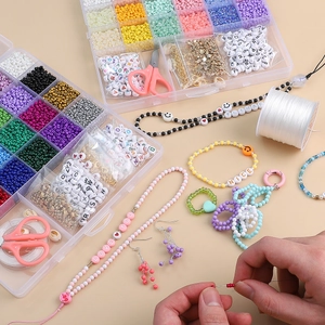 Macro shot of 24-grid DIY jewelry kit with colorful beads, letter charms, and tools