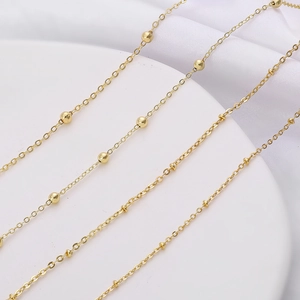 Macro detail of golden bead chain with satellite links for DIY jewelry making accessories