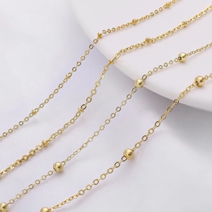 Detail of delicate gold bead chain link for DIY jewelry making and handmade accessories