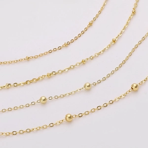Detail shot of delicate gold-plated copper satellite chain with evenly spaced round beads