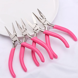 Macro shot of four pink jewelry pliers set including round and needle nose tools