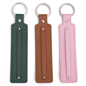 Three long leather keychains in dark green, brown, and pink with silver metal rings