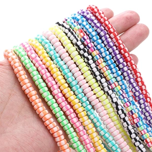 Close-up of 6x3mm colorful polymer clay beads with spiral patterns for DIY jewelry making