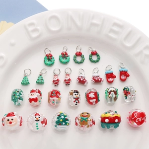 Detail showing Christmas DIY charms and hand-painted glass beads in a ceramic tray