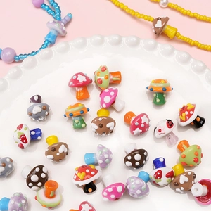 Hand-painted glass mushroom beads in various colors and patterns for DIY jewelry making