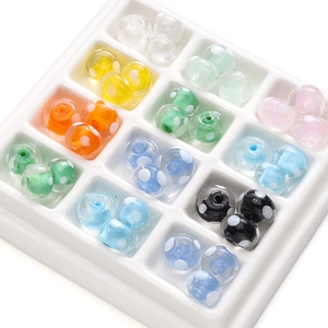 Colorful polka dot glass beads in a white tray for handmade jewelry DIY necklaces