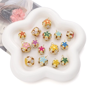 Detail of colorful cloisonne enamel hollow flower beads displayed on a star ceramic tray