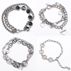 Macro detail of assorted stainless steel DIY chains with heart and flower pendants