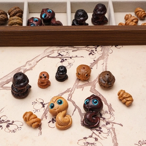 Detail of hand-carved wooden zodiac snake beads for DIY jewelry and crafts