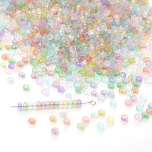 Macro detail of multi-color transparent abacus beads with a metal beading needle