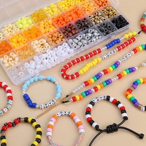 Close-up of 32-compartment DIY bead kit with colorful acrylic beads and letter charms