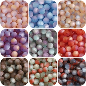 Detail of matte resin cat-eye beads with smooth satin texture and center hole for DIY
