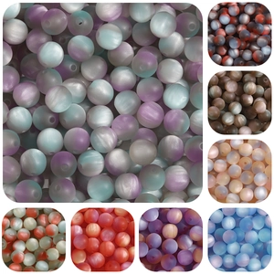 Detailed macro of 8/10mm matte resin cat-eye beads in various gradient color variants