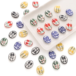 Detailed view of hand-painted ceramic tulip beads with glossy white glaze for DIY jewelry