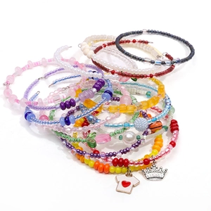 Colorful multi-layer beaded bracelet set with blue and purple glass beads and metal charms