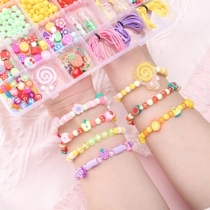 Detailed view of DIY fruit bead jewelry kit with handmade bracelet on a pink fabric