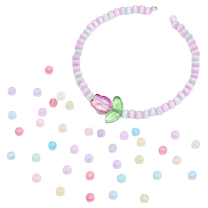 Macro detail of DIY jelly cat eye glass beads with a tulip pendant for jewelry making