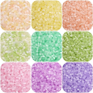 Nine colorful cat-eye glass beads in grid layout for DIY jewelry and accessory making