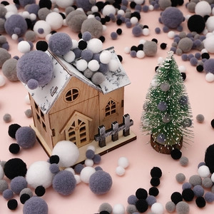Close-up of assorted plush pom poms in neutral colors for DIY doll decoration