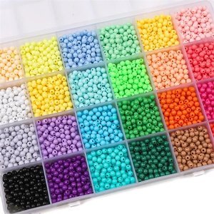 Overhead close-up of 24-grid box with 4mm colorful acrylic macaron beads for DIY jewelry