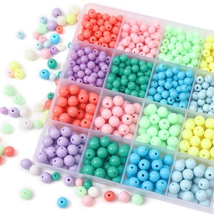 Close-up of vibrant acrylic beads in a clear organizer box for DIY jewelry making