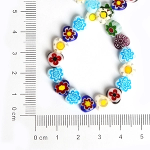 Colorful heart millefiori glass beads for jewelry making shown with a centimeter ruler