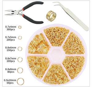 DIY jewelry making kit with golden jump rings in a plastic box and essential repair tools