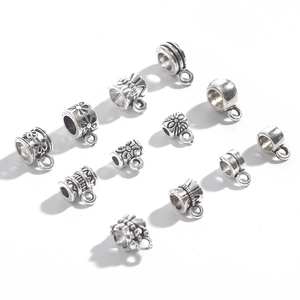 Antique silver cylinder DIY jewelry connectors with retro patterns on white background