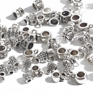 Variety of antique silver alloy spacer beads and DIY jewelry charms on white background