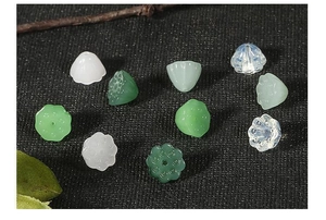 Detailed close-up of 10mm lotus bud and seed pod resin beads for DIY hairpins