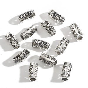 Macro detail of hollow alloy tube beads with vintage patterns for DIY jewelry making