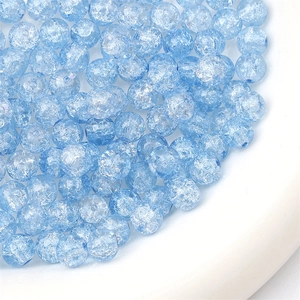 Macro detail of 8mm light blue crackle glass beads with internal ice textures for DIY jewelry