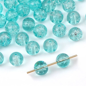 Macro shot of 8/10mm crackle glass beads in cyan blue for DIY jewelry making and crafting