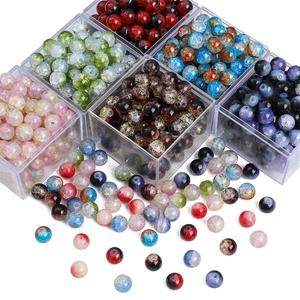 Macro shot of colorful 8mm/10mm crackle glass beads in organized storage boxes