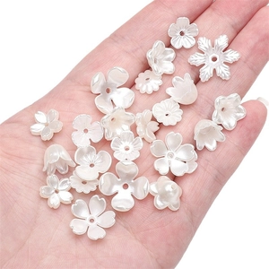 Handheld view of white ABS imitation pearl flower beads for DIY jewelry and crafts