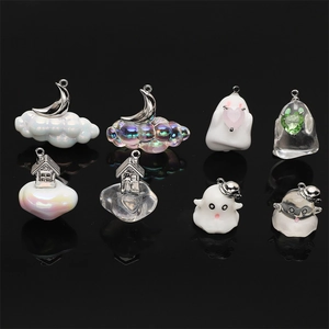 Macro shot of 8 assorted resin Halloween charms including clouds, moons and ghosts