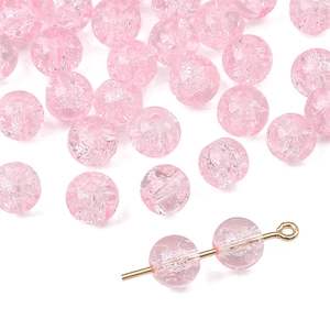 Macro detail of pink crackle glass beads showing internal texture and hole placement