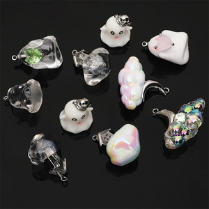 Macro view of Halloween resin charms featuring ghosts clouds and moon for DIY jewelry