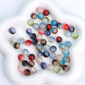 Vibrant 8mm and 10mm crackle glass beads for DIY jewelry making in a white ceramic dish