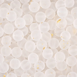 Macro shot of frosted white glass beads with gold foil flakes for DIY jewelry making