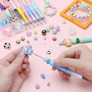 DIY bead pen kit with gradient metal barrels and colorful acrylic beads in storage box