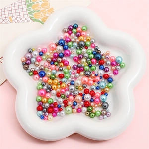 Close-up of colorful ABS imitation pearls in various sizes for DIY jewelry crafts