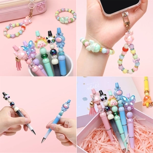 Close-up of DIY beaded pens and charms with cute astronaut and panda cartoon characters
