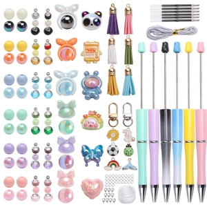 Detailed flat lay of DIY bead pen set with colorful beads, tassels, and metal pendants